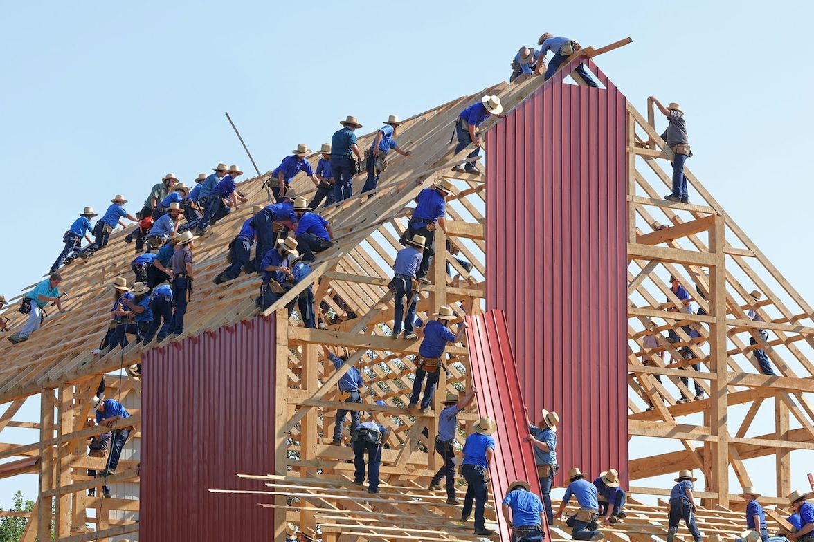 people building structure during daytime